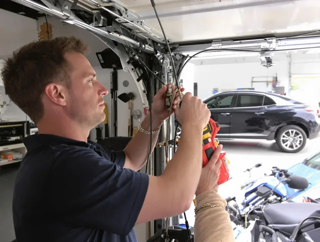 West Warwick Garage Door Repair safety certified technician performing cable replacement in West Warwick